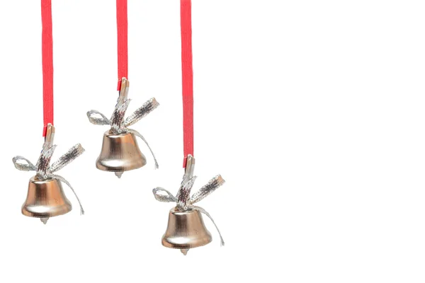 Три серебряных колокола на красных лентах — стоковое фото