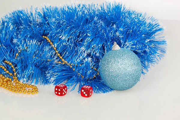 Dice with blue Christmas ball, blue and gold beads garland — Stock Photo, Image