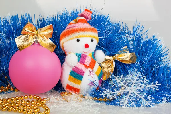 Snowman and pink Christmas ball with blue garland and golden bea Stock Picture