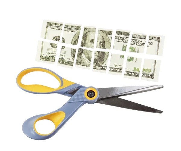 Scissors cut a hundred dollar bill into many parts — Stock Photo, Image