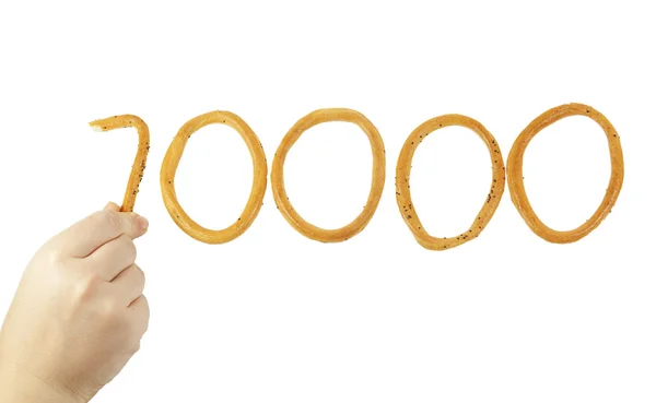 Hand zet het aantal tienduizend van bagels — Stockfoto