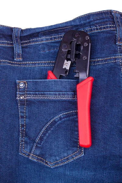 Ferramenta de friso em um bolso de calça azul — Fotografia de Stock