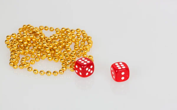 Red dice and gold beads — Stock Photo, Image