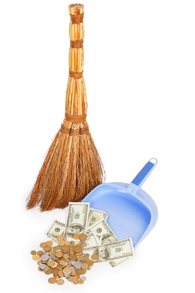 Broom and money on lilac dustpan — стоковое фото