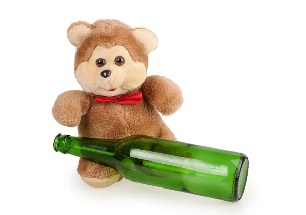 Teddy bear and an empty bottle of beer — Stock Photo, Image