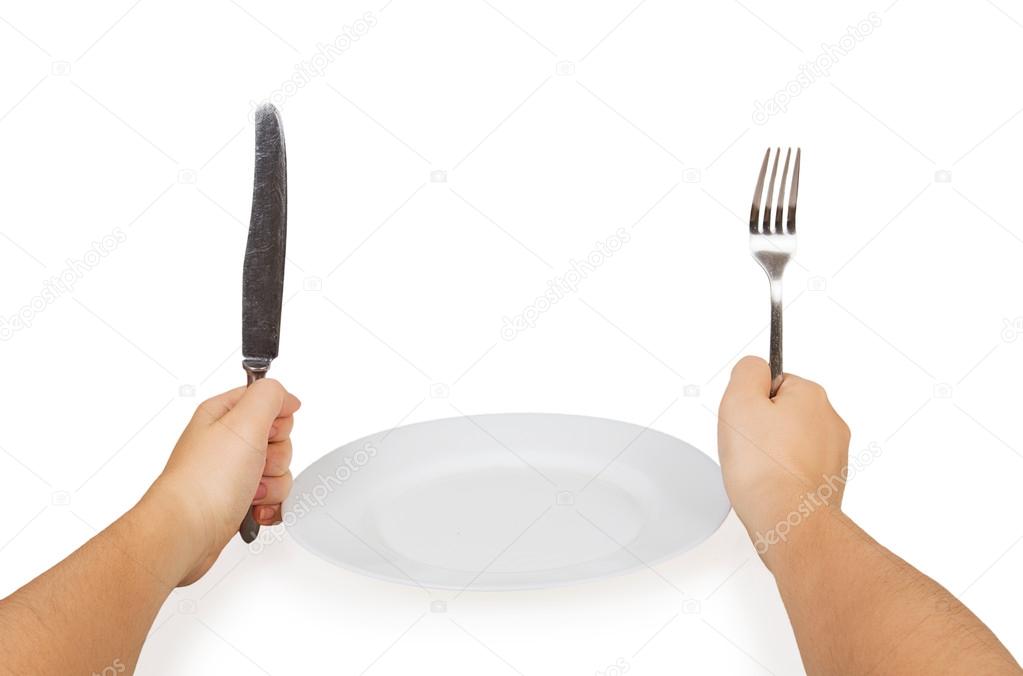 Knife and fork in hands and white plate