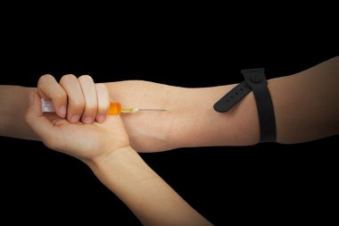 uyuşturucu bağımlısı kolundan bir ilaç şırınga ile iğneleyici.