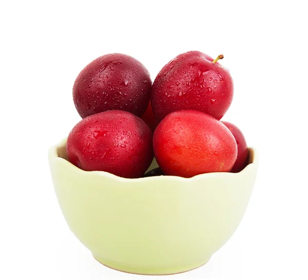 Fresh plums in green deep bowl — Stock Photo, Image