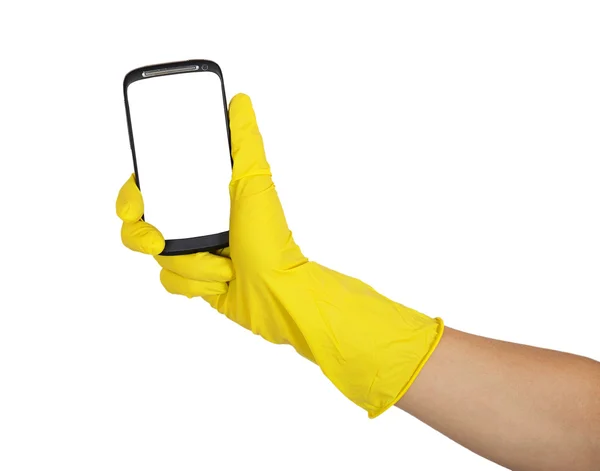 Ręka w żółty rękawica posiadania telefonu komórkowego — Zdjęcie stockowe