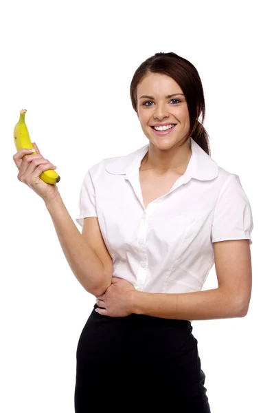 Mulher de negócios segurando uma banana — Fotografia de Stock