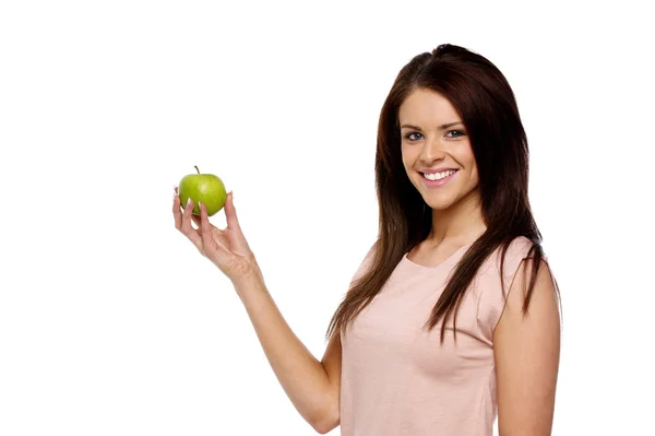 Brunette woman holding up an apple — Stock Photo, Image