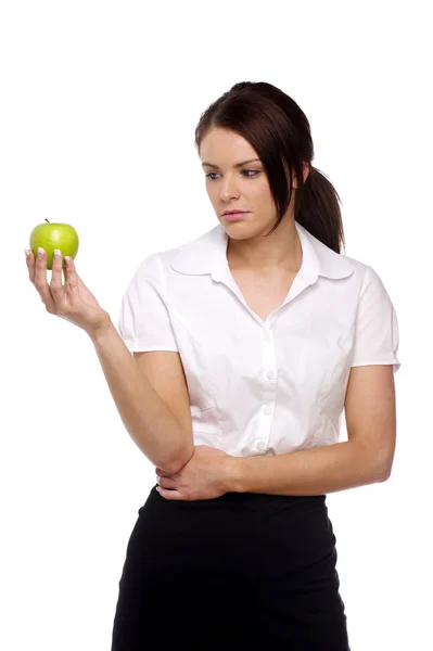 Business woman looking disappointingly at an apple Royalty Free Stock Photos