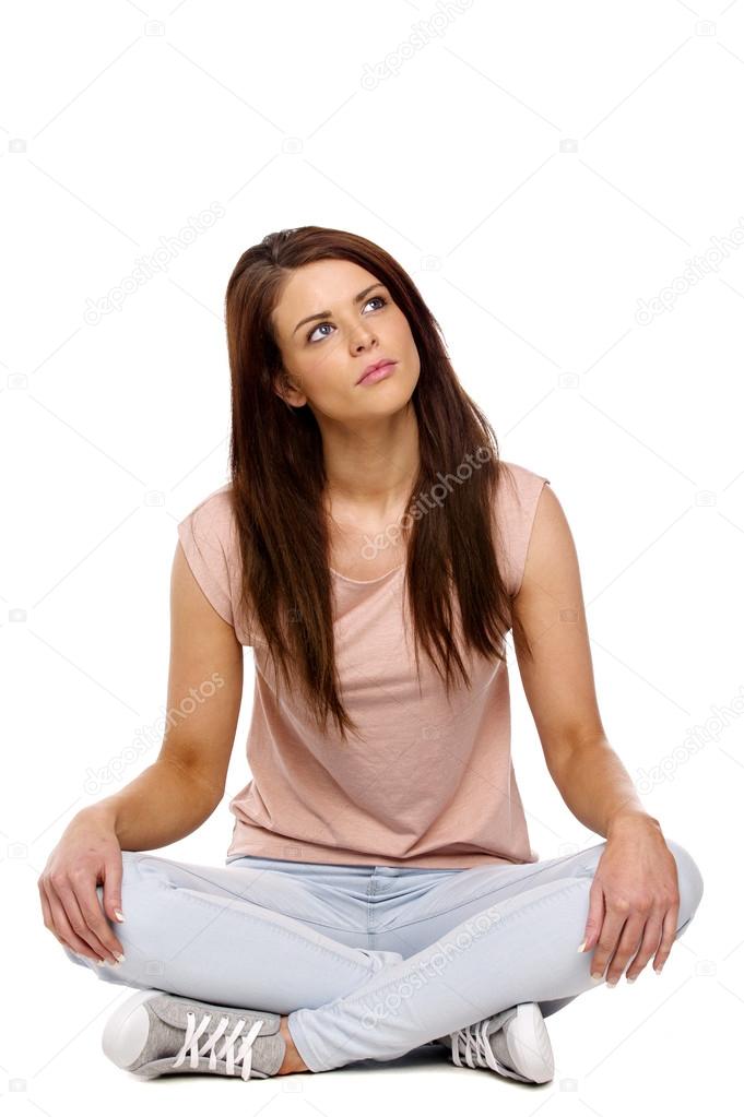 Brunette woman sat crossed legged thinking