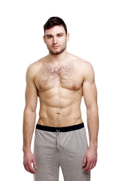 Uomo in topless in piedi su uno sfondo bianco — Foto Stock