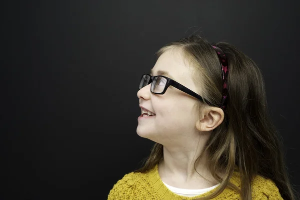 Smart young girl stood infront of a blackboard — Stock Photo, Image