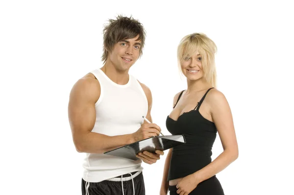 Muž a žena vyplněním formuláře izolovaných na bílém pozadí — Stock fotografie