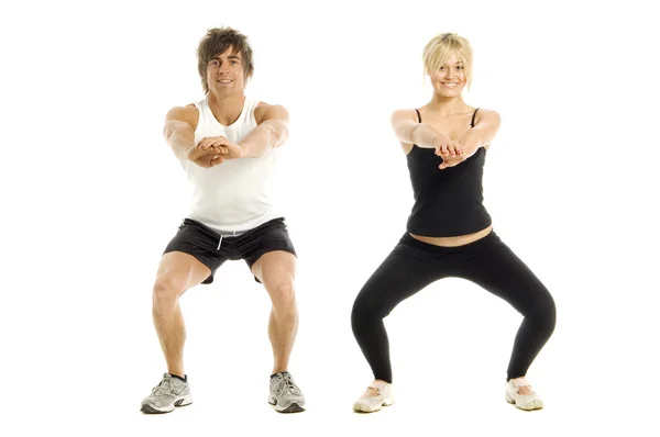 Muž a žena cvičit izolovaných na bílém pozadí — Stock fotografie