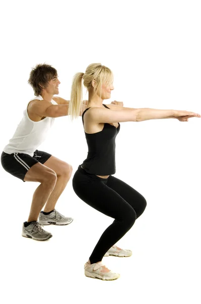Muž a žena cvičit izolovaných na bílém pozadí — Stock fotografie