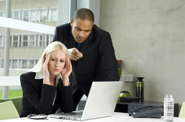 Boss lecturing employee as she works — Stock Photo, Image