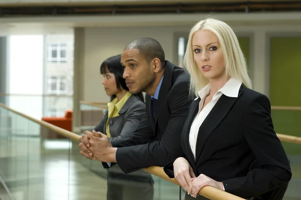 Blonde business woman and two co-workers — Stock Photo, Image