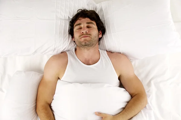 Man laid in white bed sleeping — Stock Photo, Image