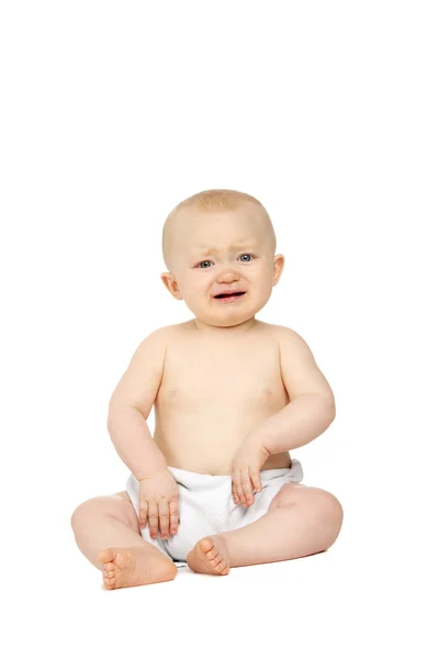 Bambino seduto isolato su uno sfondo bianco — Foto Stock