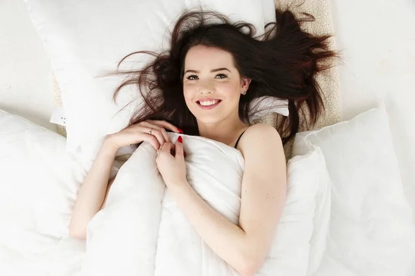 Woman laid in bed looking up — Stock Photo, Image