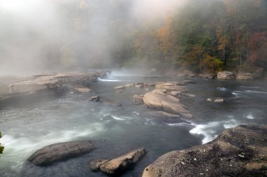 The Tygart River cascades over rocks at Valley Falls State Park clipart