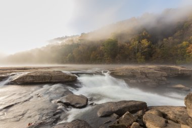 The Tygart River cascades over rocks at Valley Falls State Park  clipart