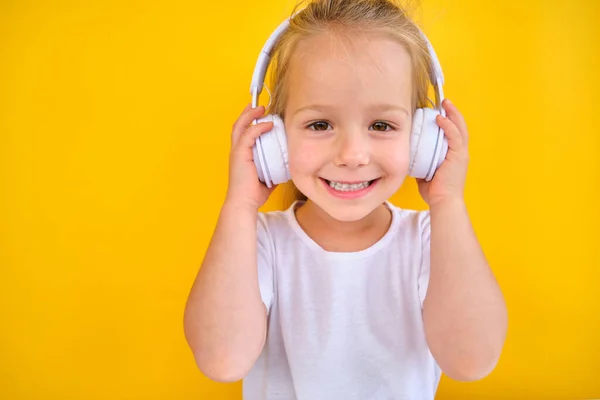 Positive Happy Little Girl Listening Music Headphones Dancing While Listening — Zdjęcie stockowe