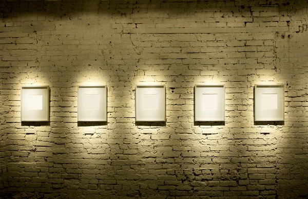 Five frames on brick wall — Stock Photo, Image