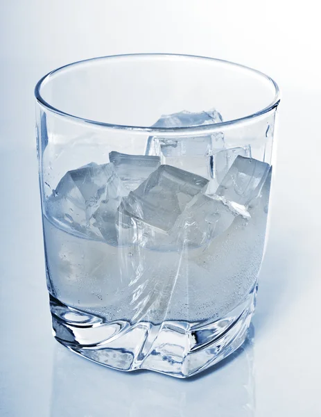 Glass with drink and ice cubes — Stock Photo, Image