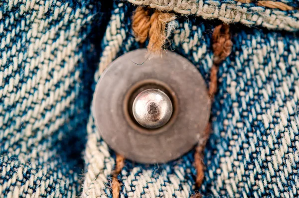 Rivet on jeans.Front focus — Stock Photo, Image