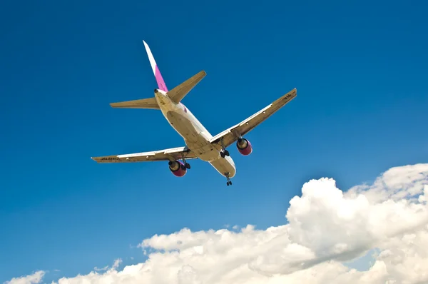 Passenger plane flying over clouds — Stock Photo, Image