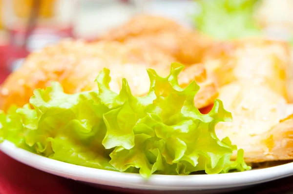 Salad and fried pies closeup