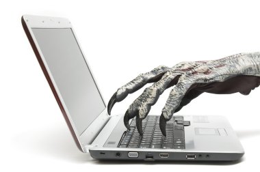 Monster hand is typing on a computer clipart