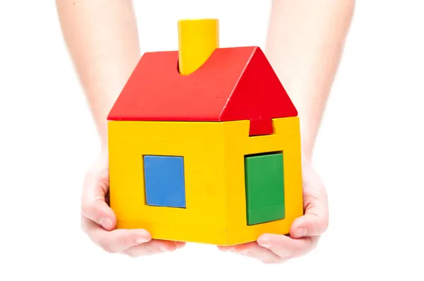 Toy house in hands on white background — Stock Photo, Image