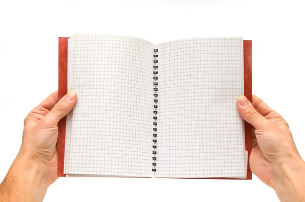 Händer som håller öppen spiral notebook — Stockfoto