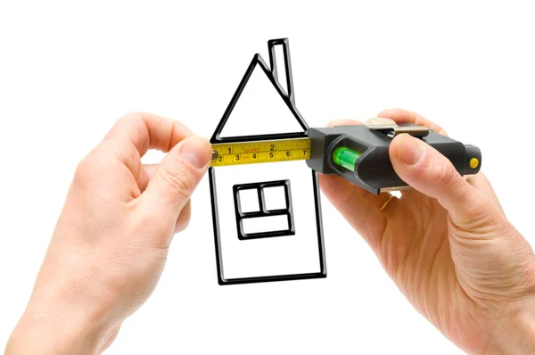 Tape-line in hands and picture of house — Stock Photo, Image