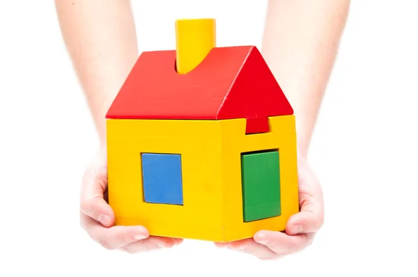 Toy house in hands on white background Royalty Free Stock Images