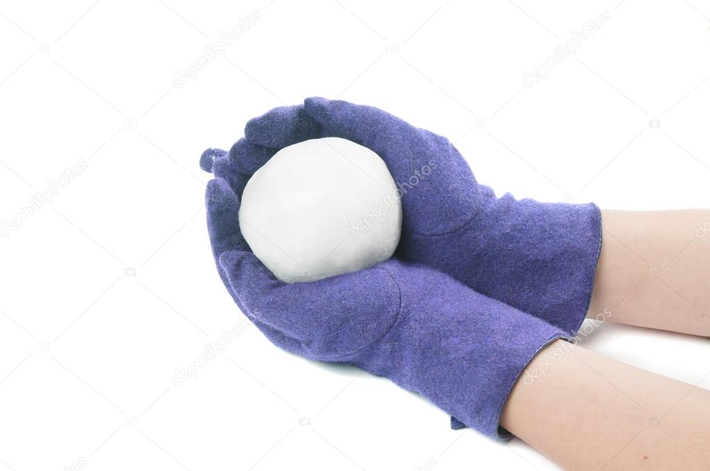 Blue gloved hands holding a snowball