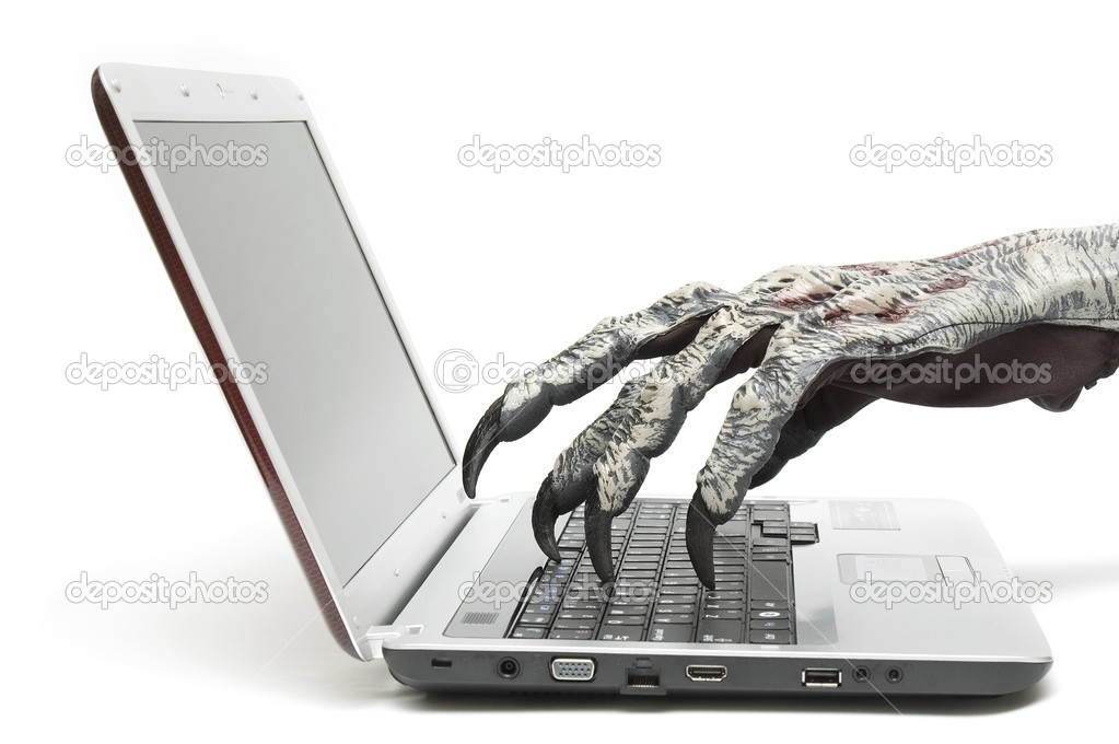 Monster hand is typing on a computer