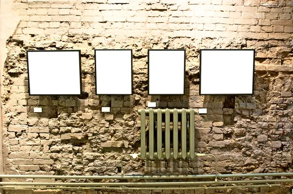 Four frames on brick wall — Stock Photo, Image