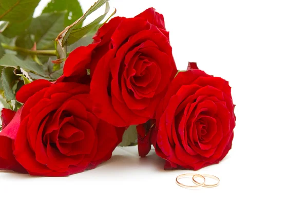 Bouquet roses and wedding rings Stock Image