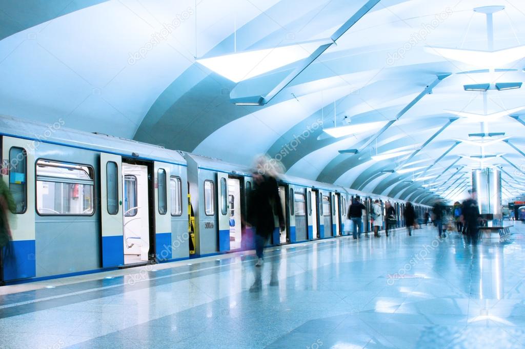 Passengers walk out from metro train