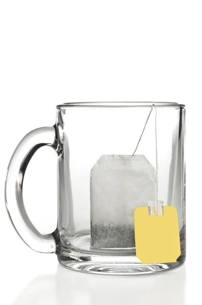 Glass mug with teabag label — Stock Photo, Image