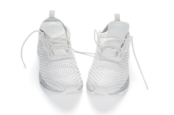 白色时髦运动鞋紧跟在白色背景上 — 图库照片
