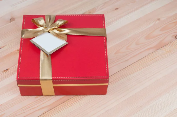 Red Gift Box Golden Ribbon Wooden Background — Stock Photo, Image