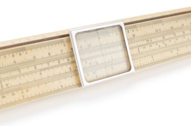 Old logarithm ruler close up on white background