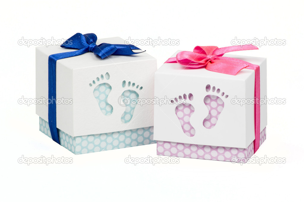 Two small boxes with gift for a newborn baby, pink and blue polka dots, top decorated with bow 